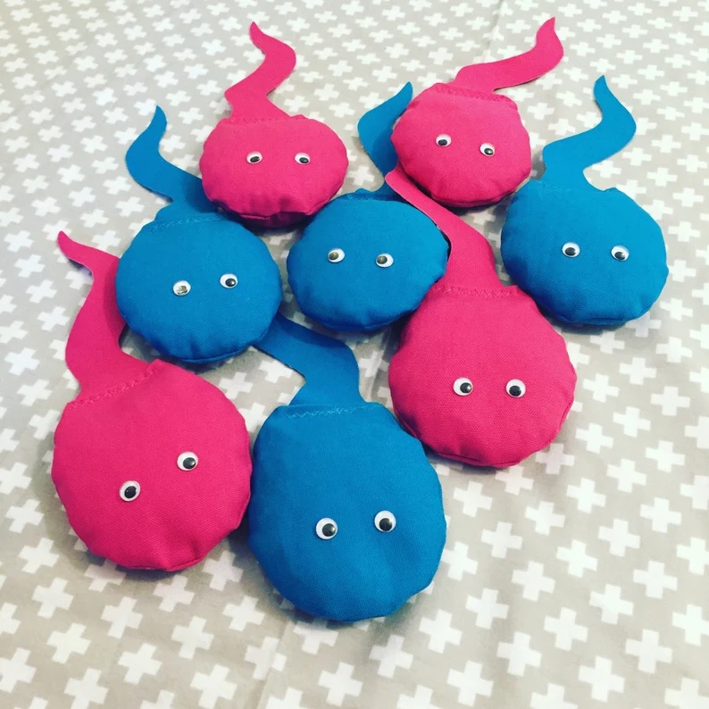 pink and blue sperm-shaped corn hole bean bags
