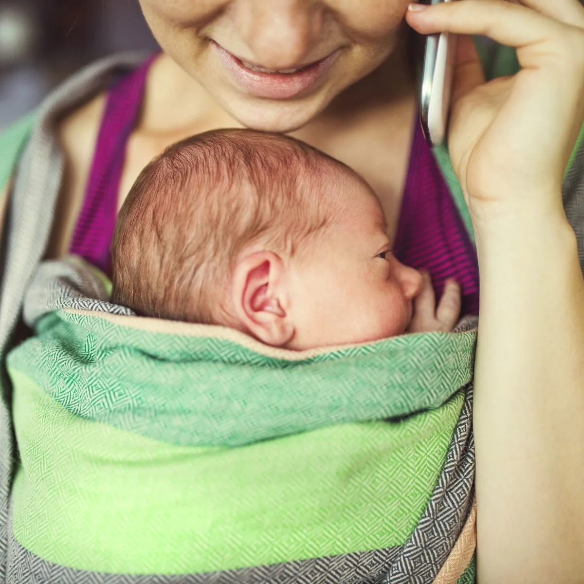 Mom wearing baby in a sling