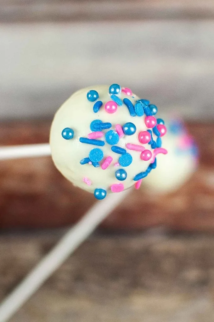 Adding sprinkles to a cake pop