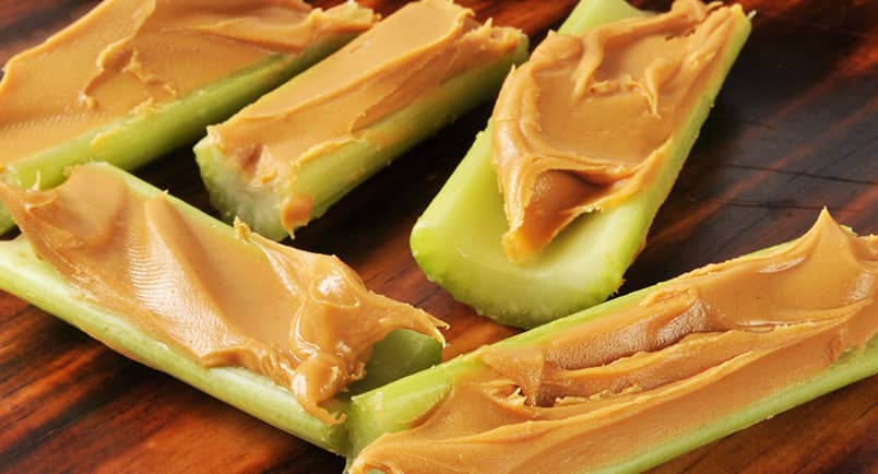 sliced celery with peanut butter inside