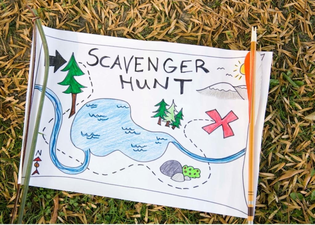 A paper with a drawn map that says "Scavenger Hunt" on the grass outside.