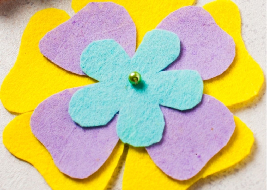 Yellow, purple, and blue flower felt craft for kids.